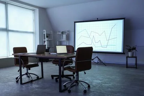 Interior of data scientist's office with workplace, laptops and diagrams on p Stock Photos