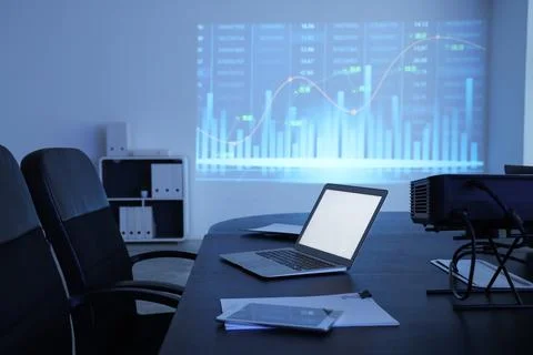 Interior of data scientist's office with workplace, laptop and diagrams proje Stock Photos