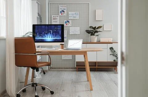 Interior of data scientist's office with workplace, pin board and diagrams Stock Photos