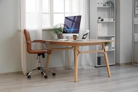 Interior of data scientist's office with workplace and shelf unit Stock Photos