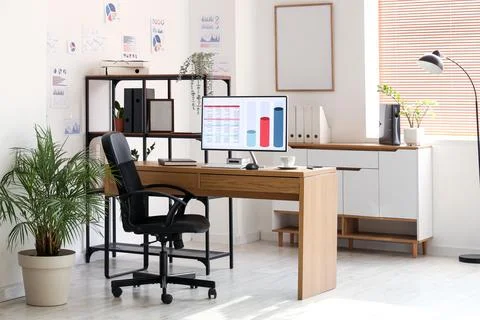 Interior of data scientist's office with workplace, shelf unit and diagrams Stock Photos