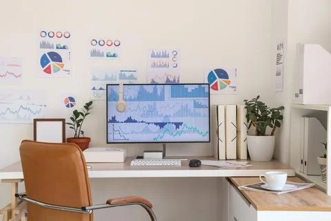 Interior of data scientist's office with workplace, diagrams and plants Foto stock