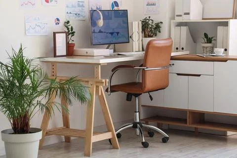 Interior of data scientist's office with workplace, diagrams and plants Stock Photos