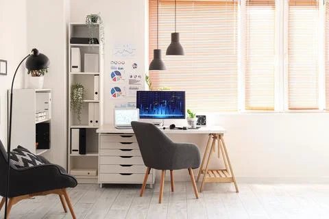 Interior of data scientist's office with workplace, shelf units and armchair Stock Photos
