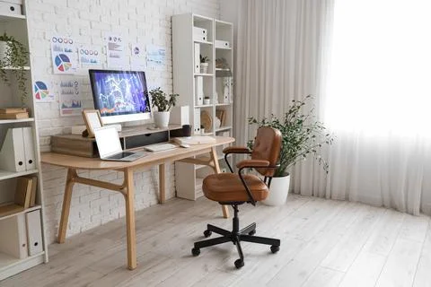 Interior of data scientist's office with workplace, diagrams and shelf units Stock Photos