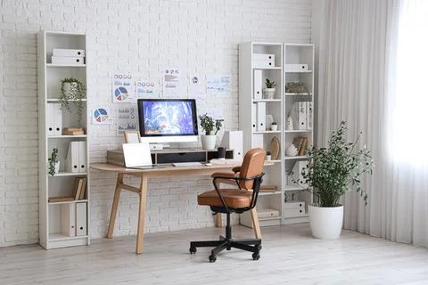 Interior of data scientist's office with workplace, diagrams and shelf units Stock Photos