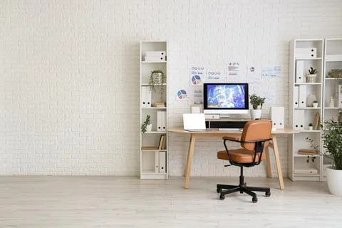 Interior of data scientist's office with workplace, diagrams and shelf units Stock Photos