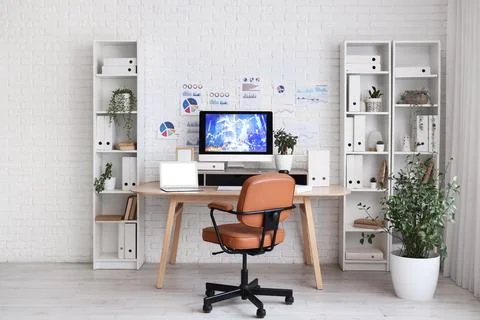 Interior of data scientists office with workplace, diagrams and shelf units Stock Photos