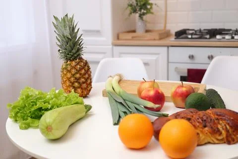 Interior decor in house kitchen table with display of fresh fruits and vegeta Stock Photos
