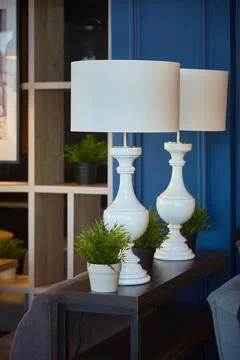 Interior decor. Two large white table lamps with large shades in a dark interior Stock Photos