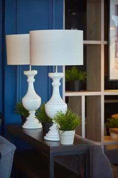 Interior decor. Two large white table lamps with large shades in a dark interior Stock Photos