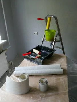 Interior decorating with wallpaper process and tools Stock Photos