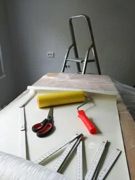 Interior decorating with wallpaper process and tools Stock Photos