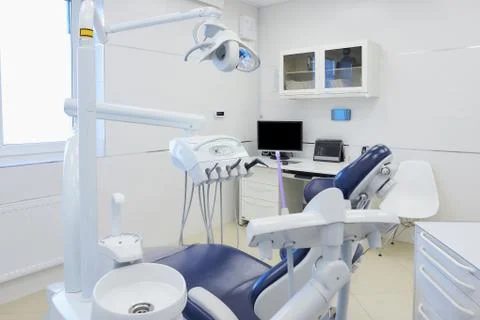 An interior of a dental office with white and blue furniture. Dentists office Stock Photos
