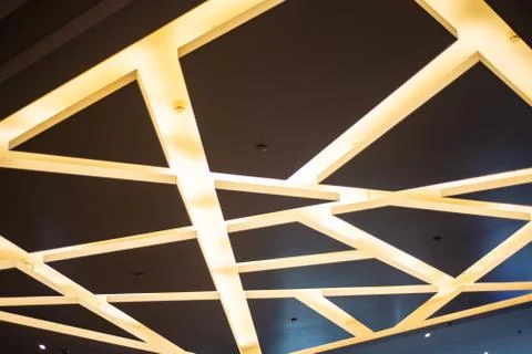 Interior design: brown ceiling with yellow lamps in the form of chaotic strip Stock Photos