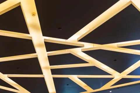 Interior design: brown ceiling with yellow lamps in the form of chaotic strip Stock Photos