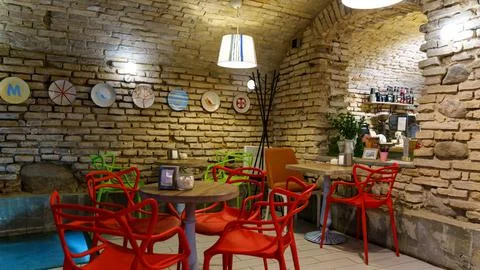 Interior design in a cafe in the loft style. Rough walls made of old red bric Stock Photos