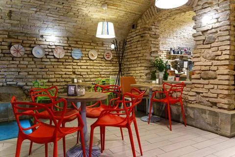 Interior design in a cafe in the loft style. Rough walls made of old red bric Stock Photos