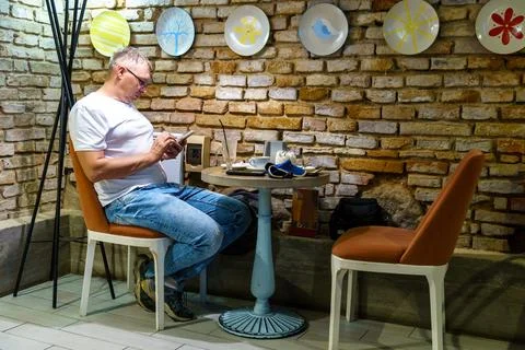 Interior design in a cafe in the loft style. A man with a phone in his hands  Stock Photos