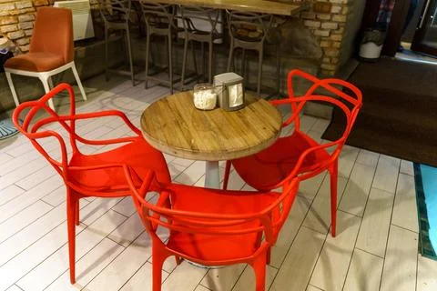 Interior design in a cafe in the loft style. Rough walls made of old red bric Stock Photos