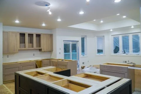 Interior design construction of kitchen with cabinet maker installing home im Foto stock