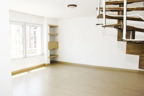 Interior design of a duplex apartment with white walls and  brown staircase Stock Photos
