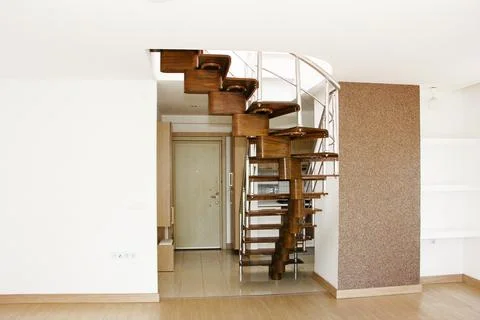 Interior design of a duplex apartment with white walls and  brown staircase Stock Photos
