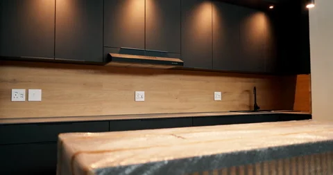 Interior design, kitchen and property with cover on counter in new home for Stock Footage 337017394