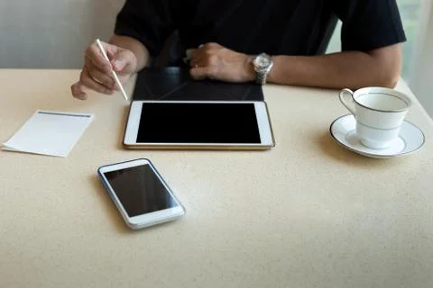 Interior design man working on tablet with coffee cup and cell p Stock Photos