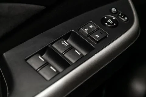 Interior design of the modern car: window adjustment buttons, door lock. luxu Stock Photos