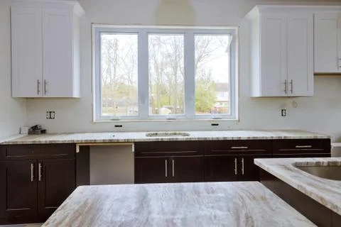 Interior design new white kitchen installing cabinets and countertop Stock Photos