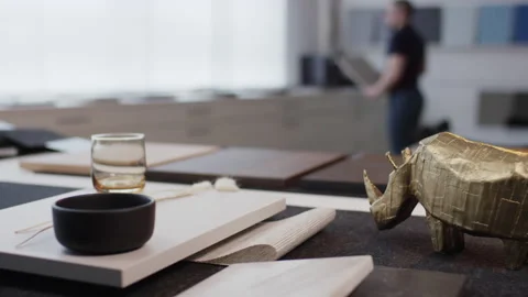 Interior design samples with glass and golden rhinoceros figurine in showroom Video stock 155208644
