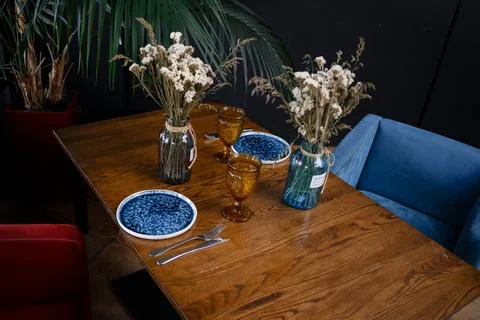 Interior design of stylish dining room interior with family wooden table, modern Stock Photos