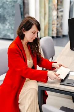 Interior designer choosing ceramic tile for new project in showroom Stock Photos