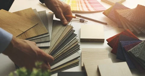 Interior designer choosing flooring and furniture materials from samples for  Stock Footage 122450145
