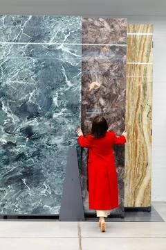 Interior designer choosing marble slabs for new project in warehouse Stock Photos