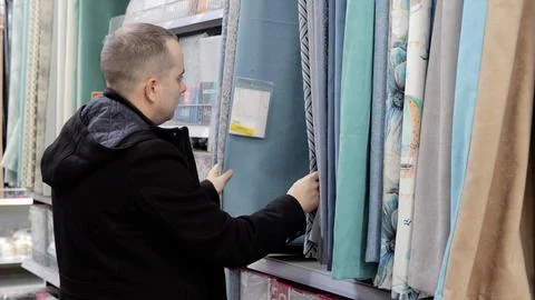 Interior designer comparing upholstery fabric samples, touching colorful Stock Photos