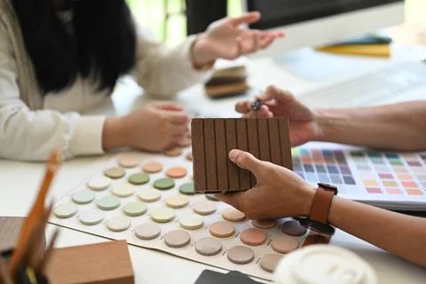 Interior designer helping client choosing colors and materials for home Stock Photos