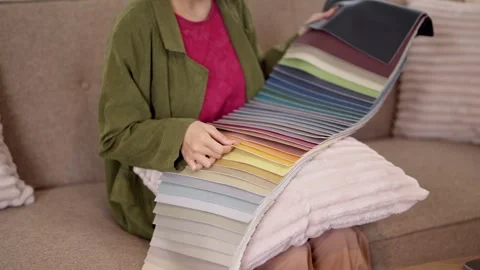 Interior designer presenting extensive fabric color swatch palette for furn.. Stock Footage 336916490
