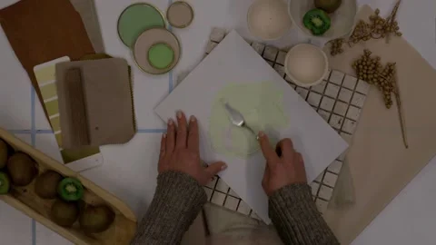 Interior designer selecting green and earthy color swatches for natural mood boa Stock Footage 329827626