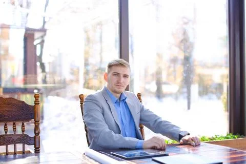 Interior designer sitting at cafe, using smart watch near roll p Foto stock