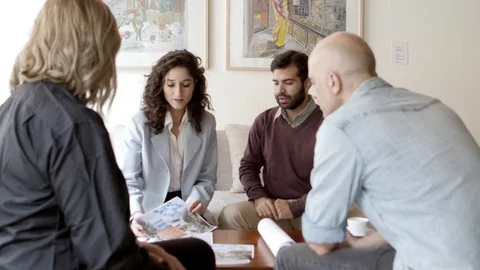 Interior designer talking with clients at home Stock Footage 121003265