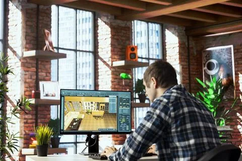 Interior designer uses 3D modeling program, selecting furniture from catalog Stock Photos