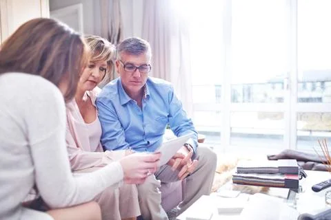 Interior designer using digital tablet in consultation with couple Foto stock