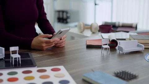 Interior designer using smartphone selecting color palette furniture materi.. Stock Footage 336484353