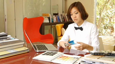 Interior designer working and typing on laptop computer Stock Footage 36239945