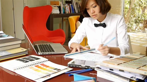 Interior designer working and typing on laptop computer Stock Footage 36239971