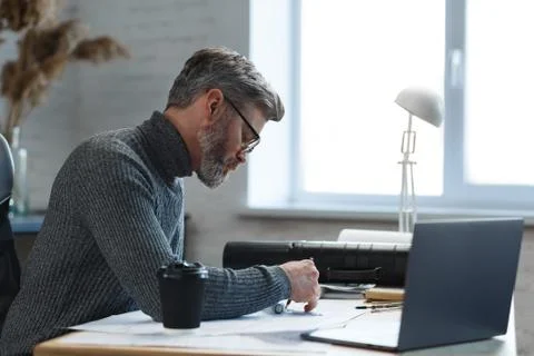 Interior designer working in office with blueprints.Engineer inspect Stock Photos