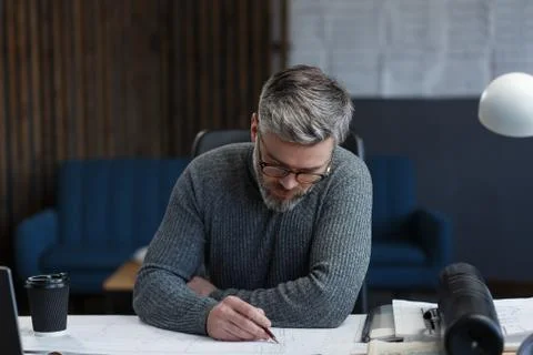 Interior designer working in office with blueprints.Engineer inspect Stock Photos