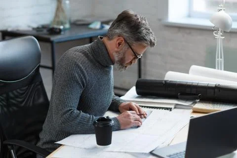 Interior designer working in office with blueprints.Engineer inspect Stock Photos